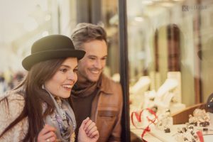 a man and woman looking at jewelry